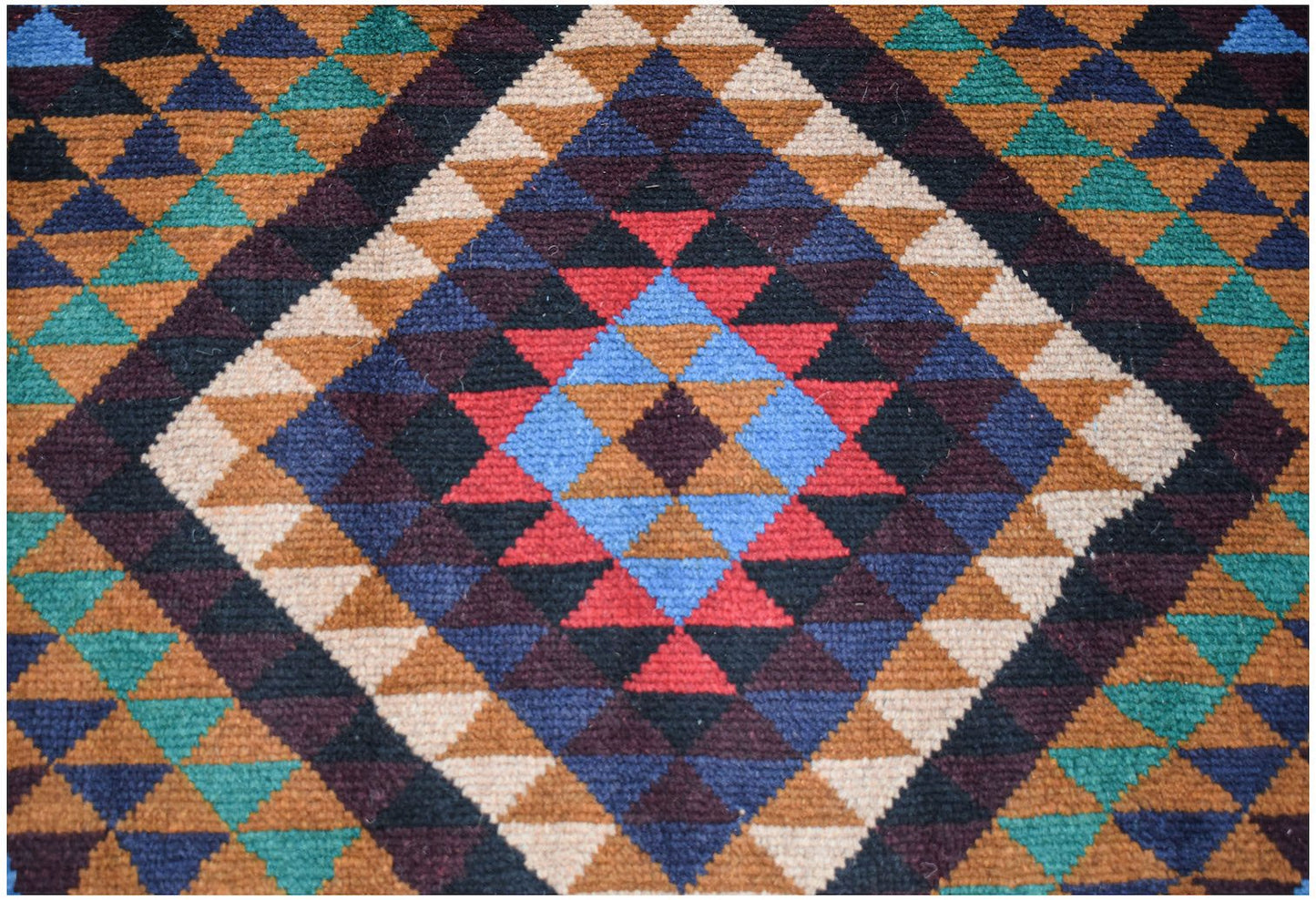 Handmade Afghan Pashm rug featuring a geometric diamond pattern in shades of red, blue, and brown.