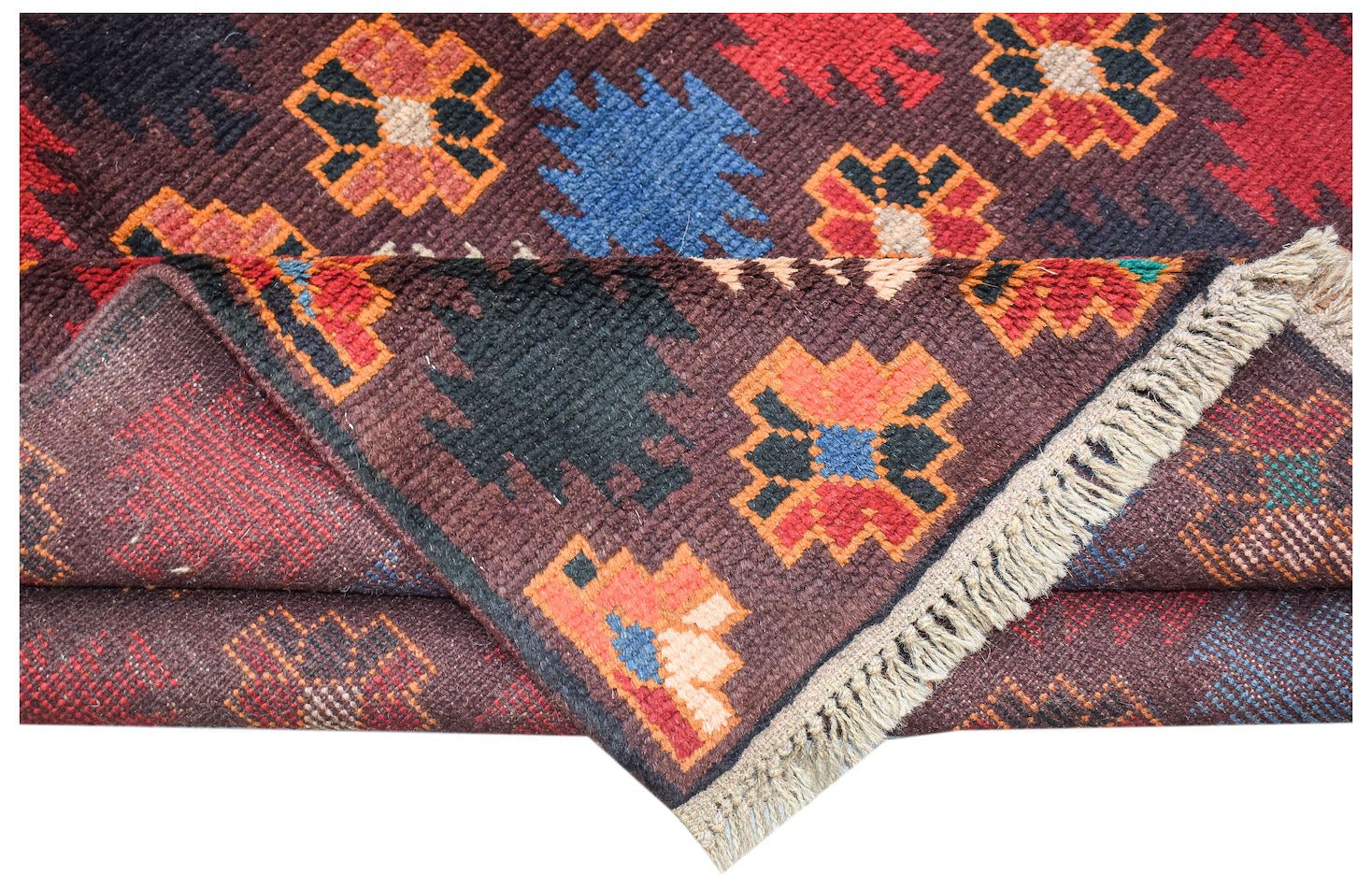 A handmade Afghan Pashm rug featuring geometric floral motifs in red, blue, and brown wool.