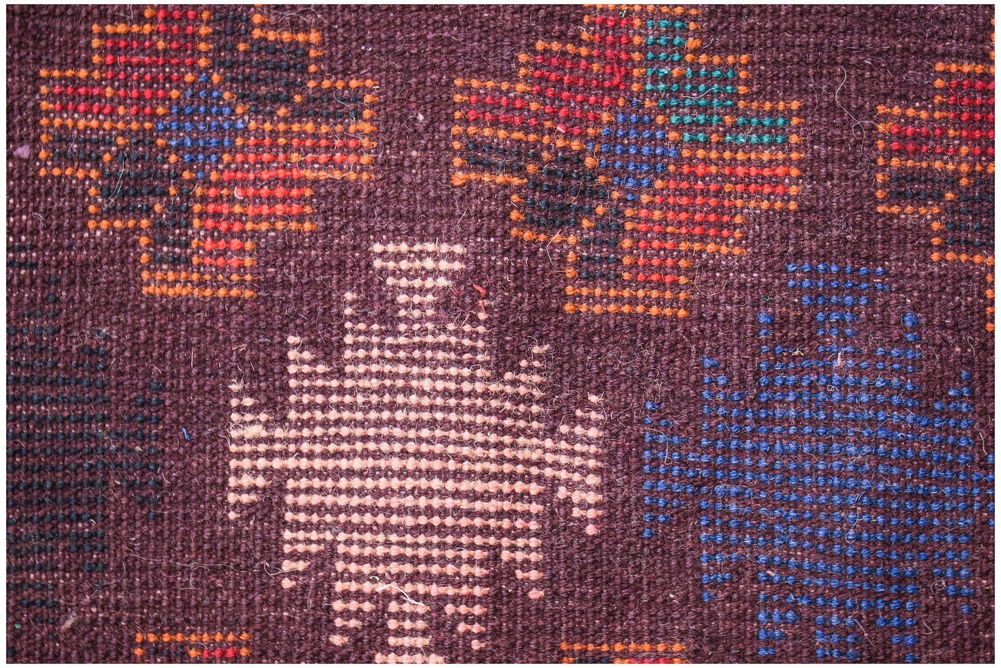 Handmade Afghan Pashm rug featuring geometric tribal patterns in red, blue, and ivory on brown.