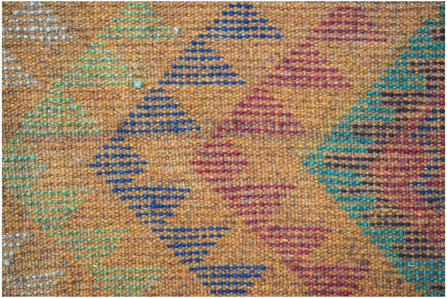 Handmade Afghan wool rug featuring a geometric diamond pattern in blue, green, and magenta.