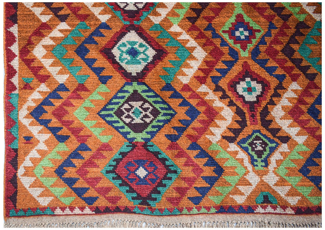 Handmade Afghan Pashm rug featuring a vibrant geometric diamond pattern in wool.