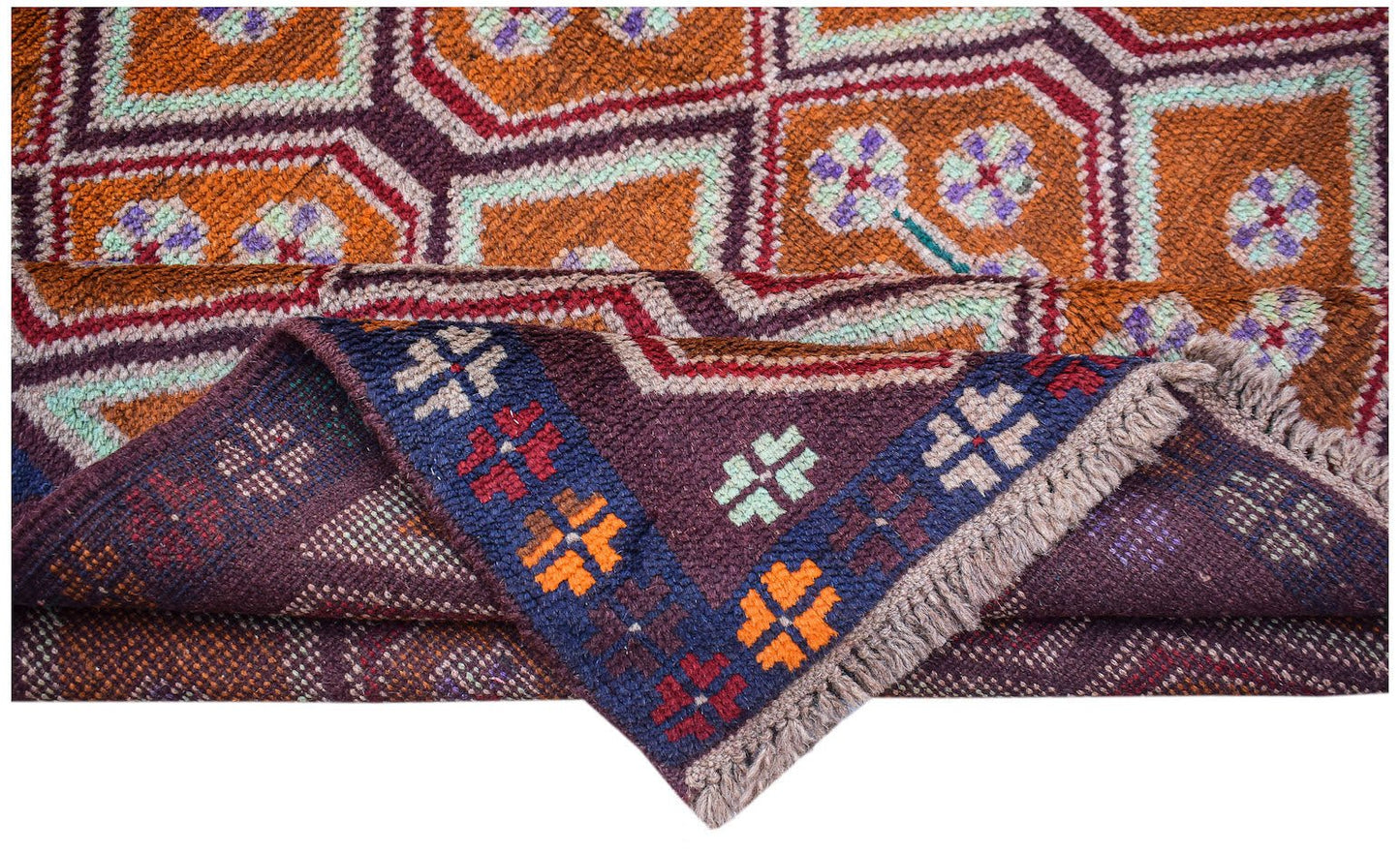 A handmade Afghan Pashm rug featuring geometric patterns in orange, purple, and deep blue.