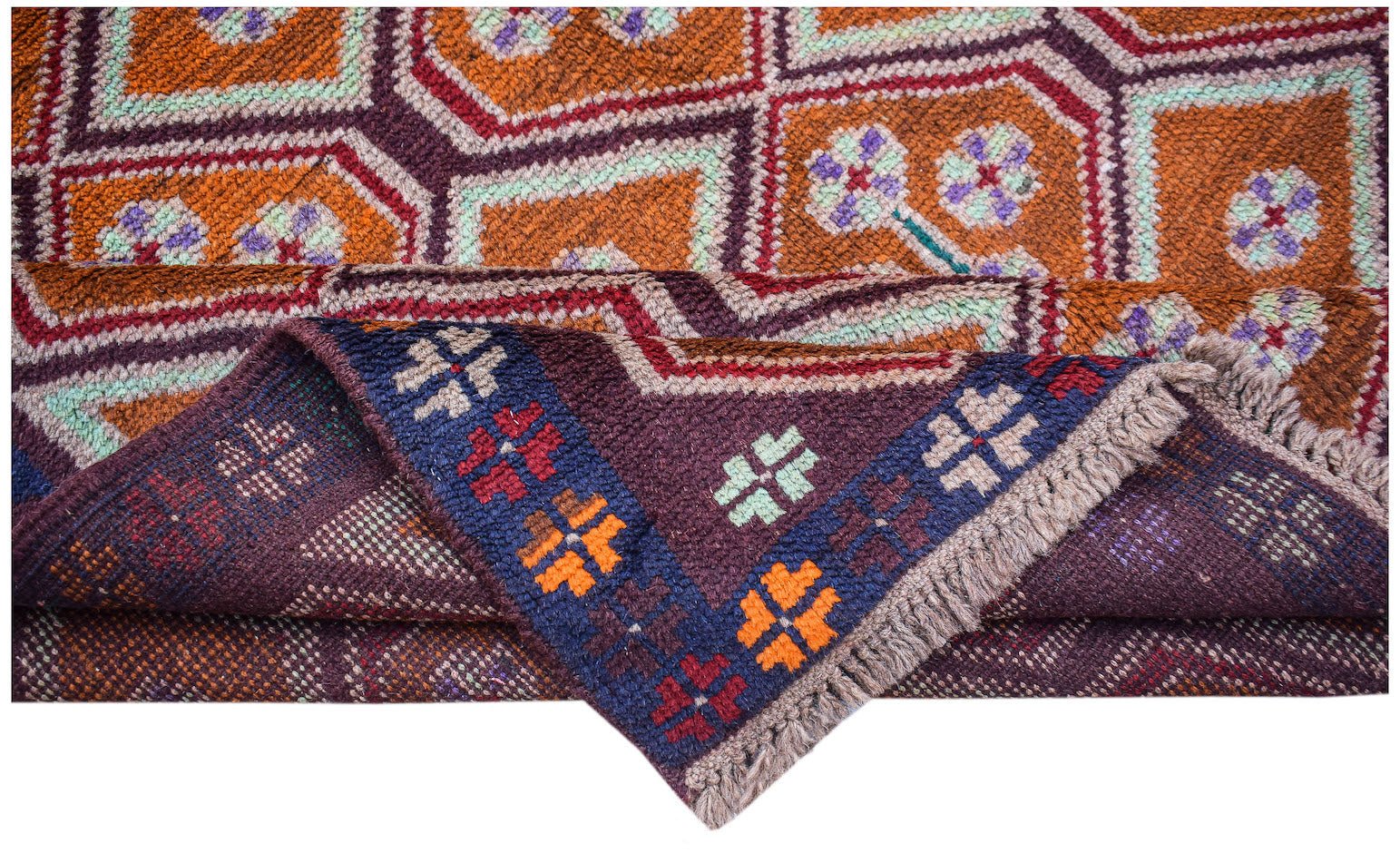 A handmade Afghan Pashm rug featuring geometric patterns in orange, purple, and deep blue.