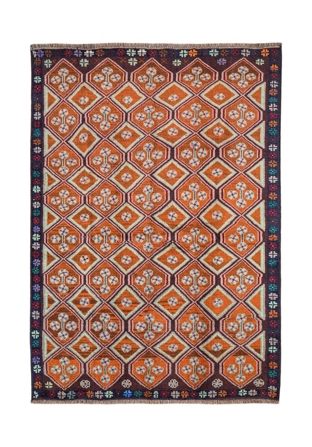 Handmade Afghan Pashm rug featuring a geometric diamond pattern in shades of orange and brown.
