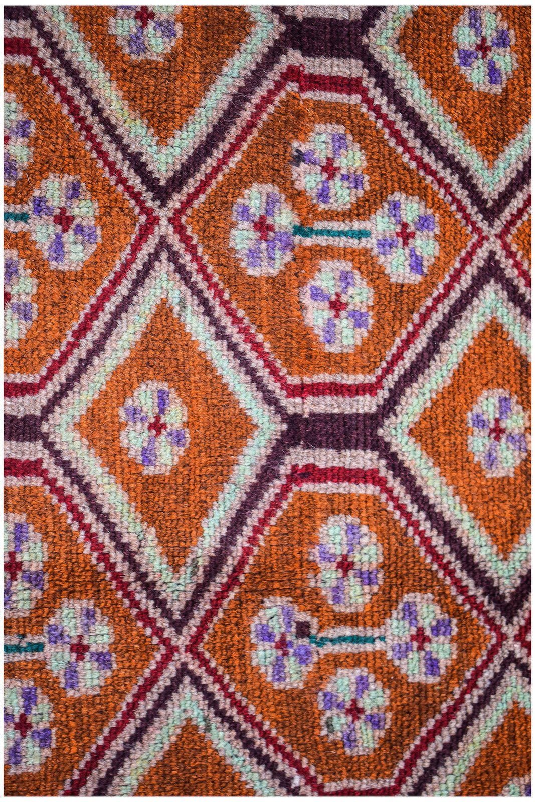 Afghan Pashm rug with a diamond pattern in orange, purple, and mint green.