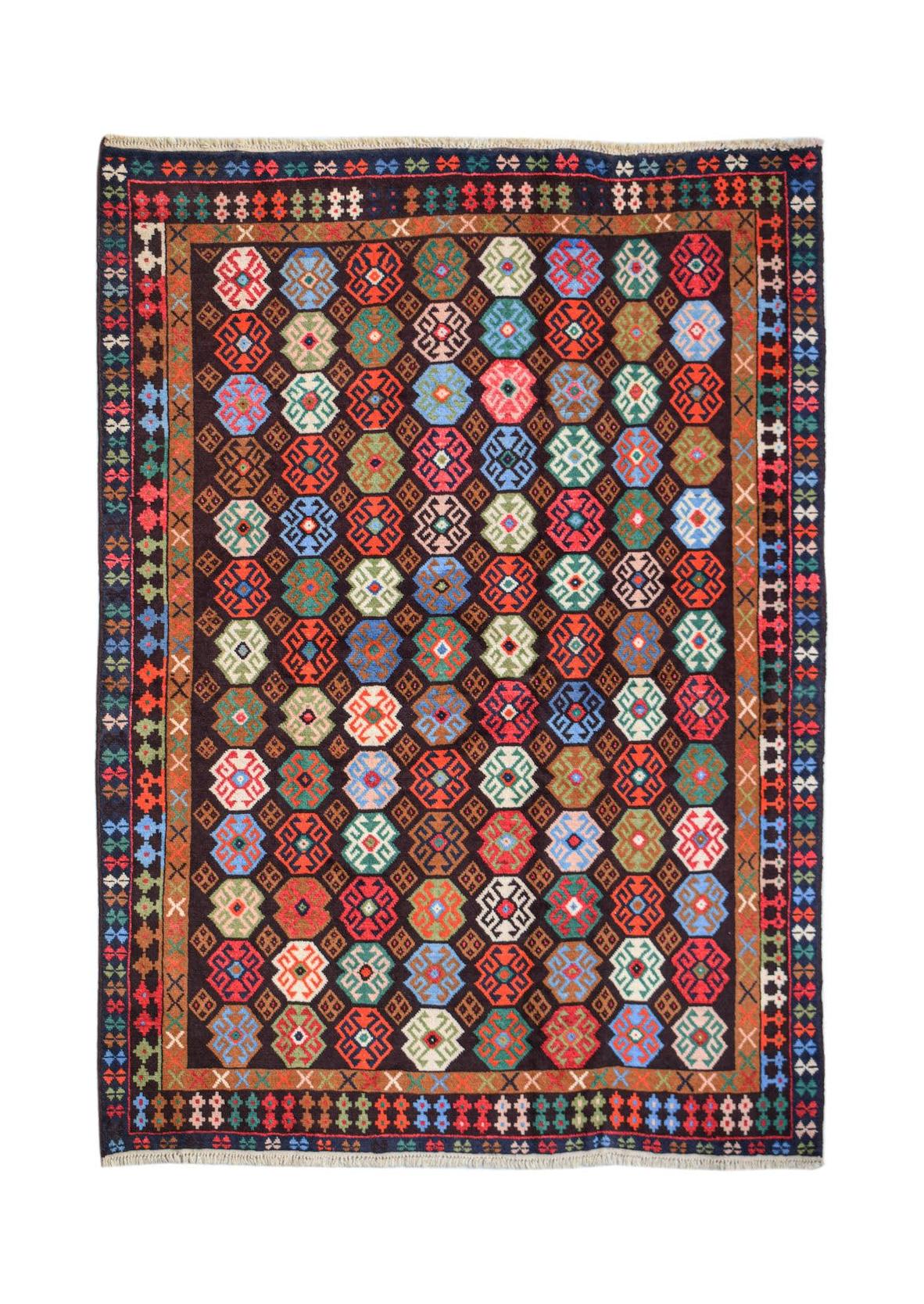 Handmade Afghan Pashm rug featuring a dark field with colorful geometric octagonal motifs.