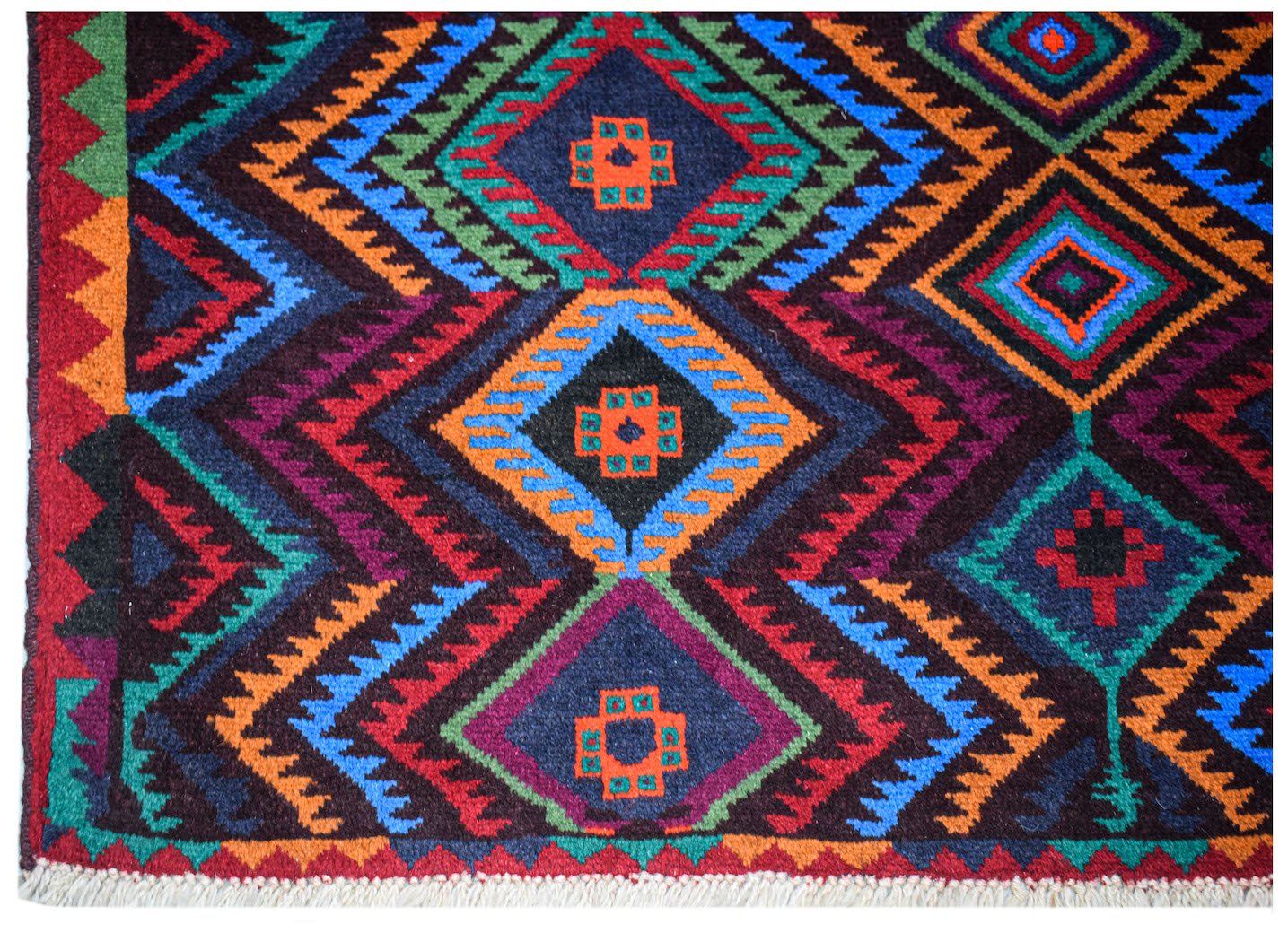 Handmade Afghan Pashm rug featuring a geometric diamond pattern in vibrant red, blue, and orange.