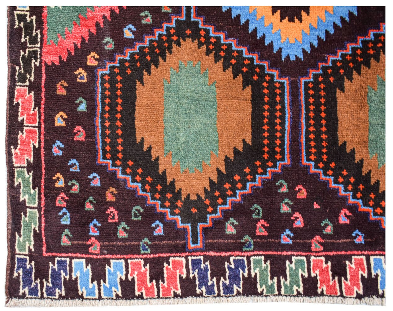 Handmade Afghan Pashm rug featuring geometric diamond patterns in brown, blue, and red wool.