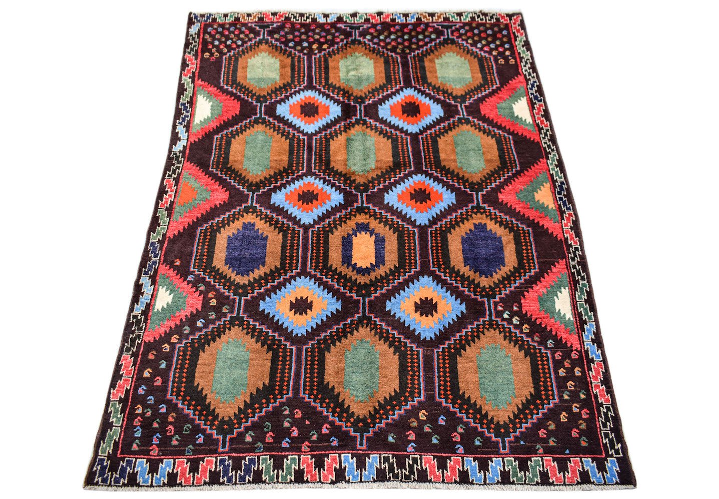 Handmade Afghan Pashm rug featuring a geometric pattern of colorful hexagons on a dark background.