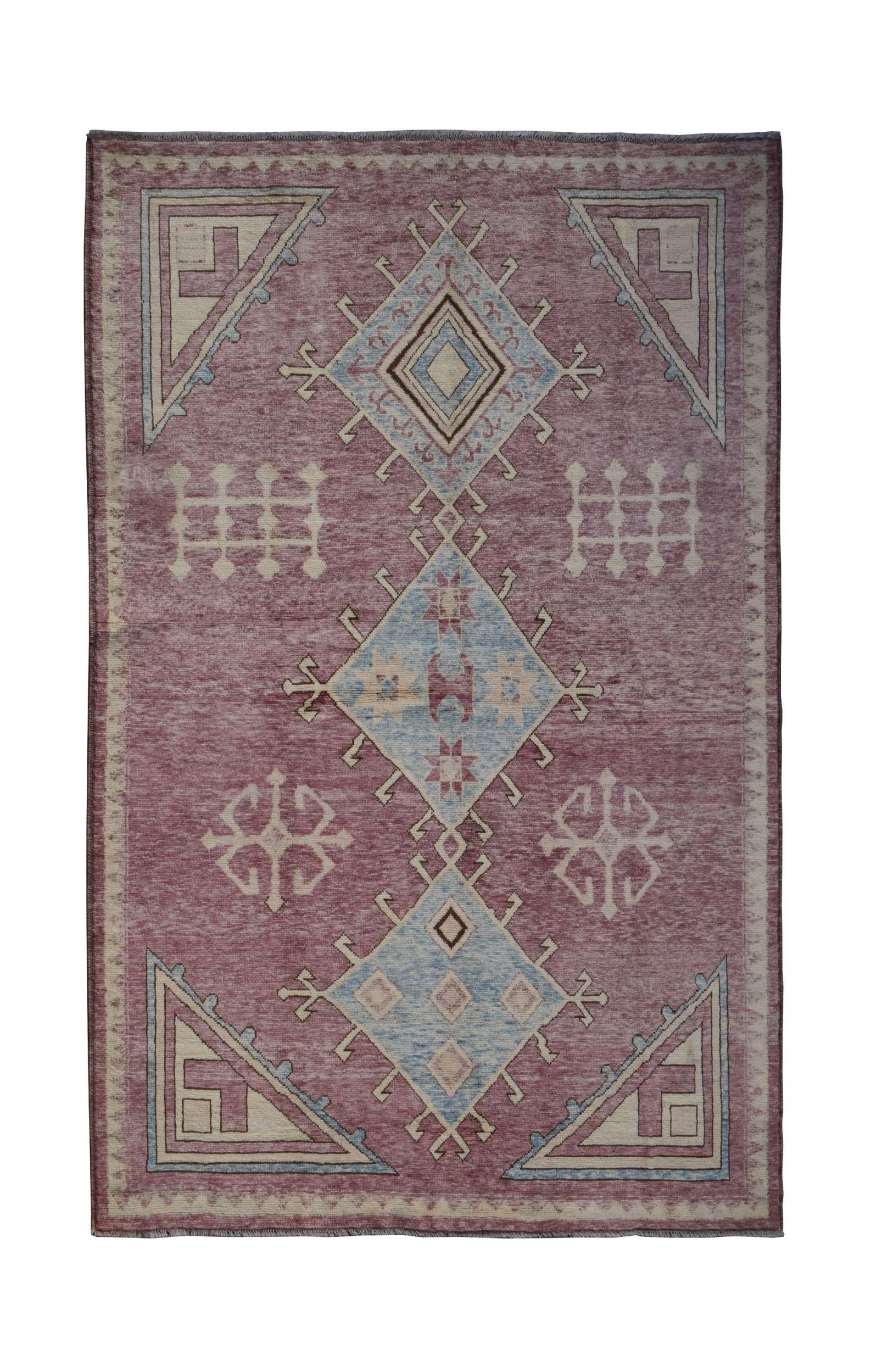 A handmade Afghan wool rug featuring a geometric diamond pattern in muted red and blue tones.