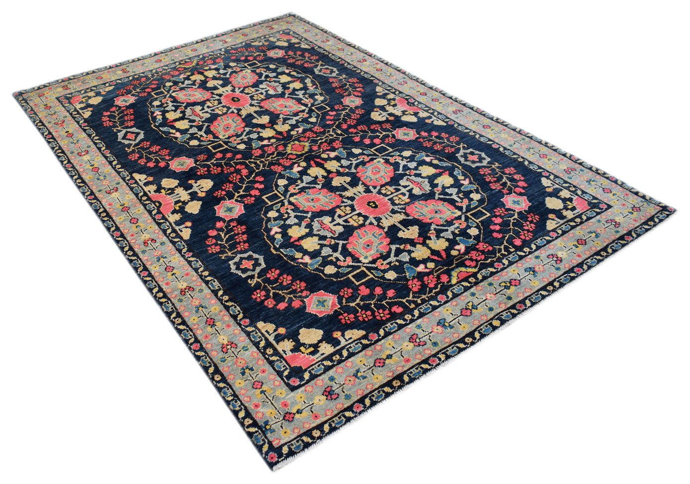 Handmade Afghan Pashm wool rug featuring two large floral medallions on a dark blue background.