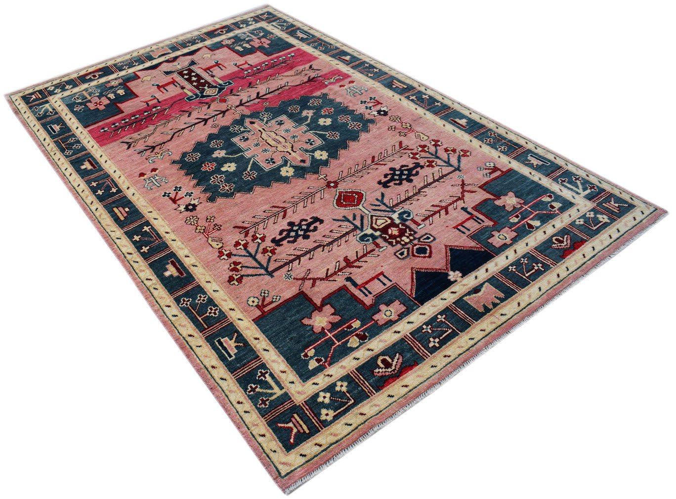 Handmade Afghan wool rug featuring a pink field with a central blue medallion and tribal motifs.