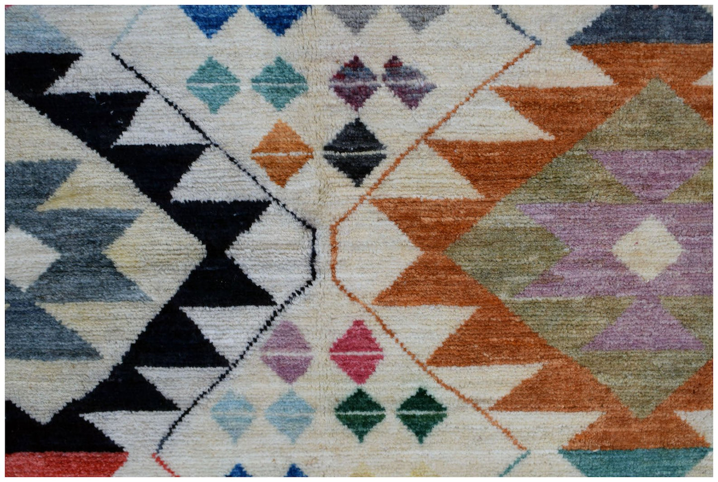 Handmade Afghan wool rug featuring a geometric tribal pattern in vibrant multicolored diamonds.