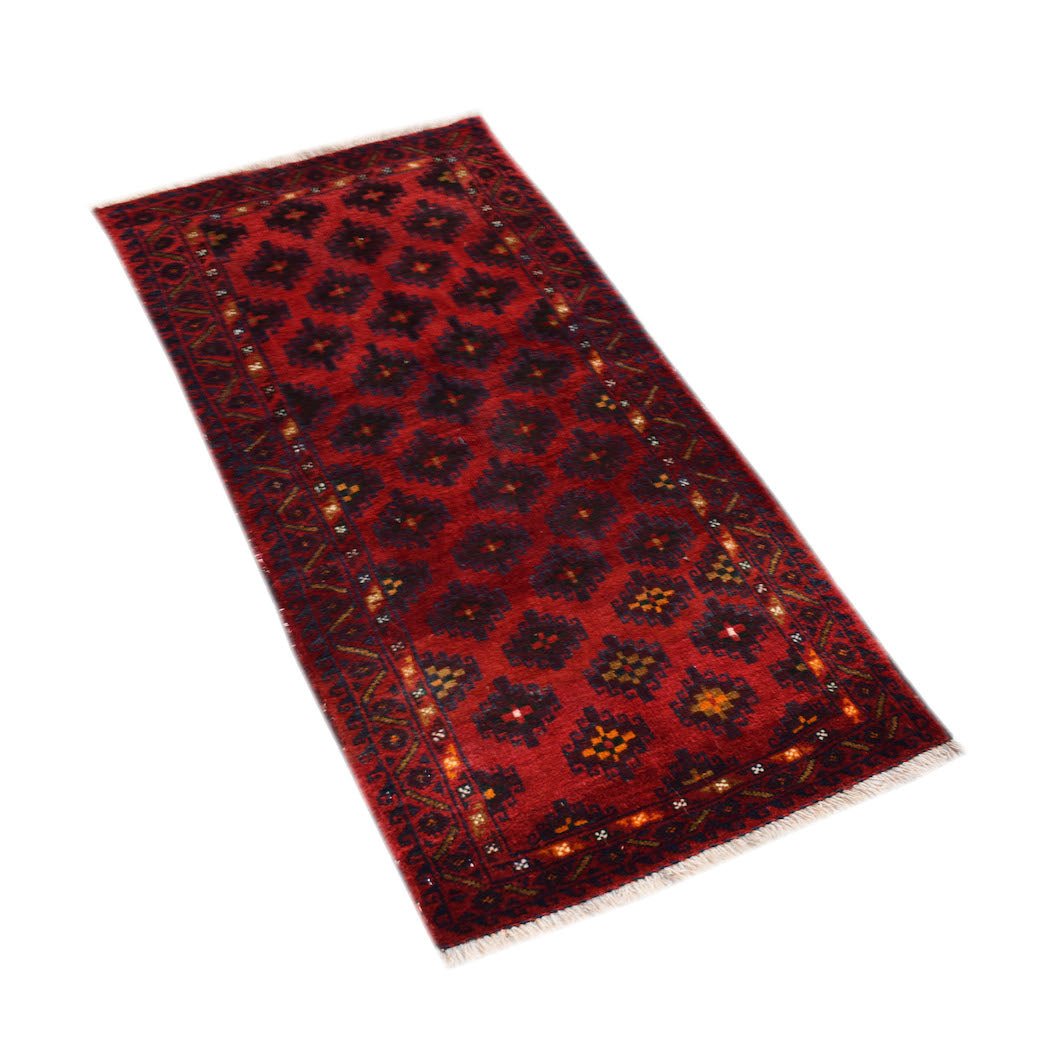A rectangular vintage Afghan Baluch rug featuring a repeating dark geometric pattern on red wool.