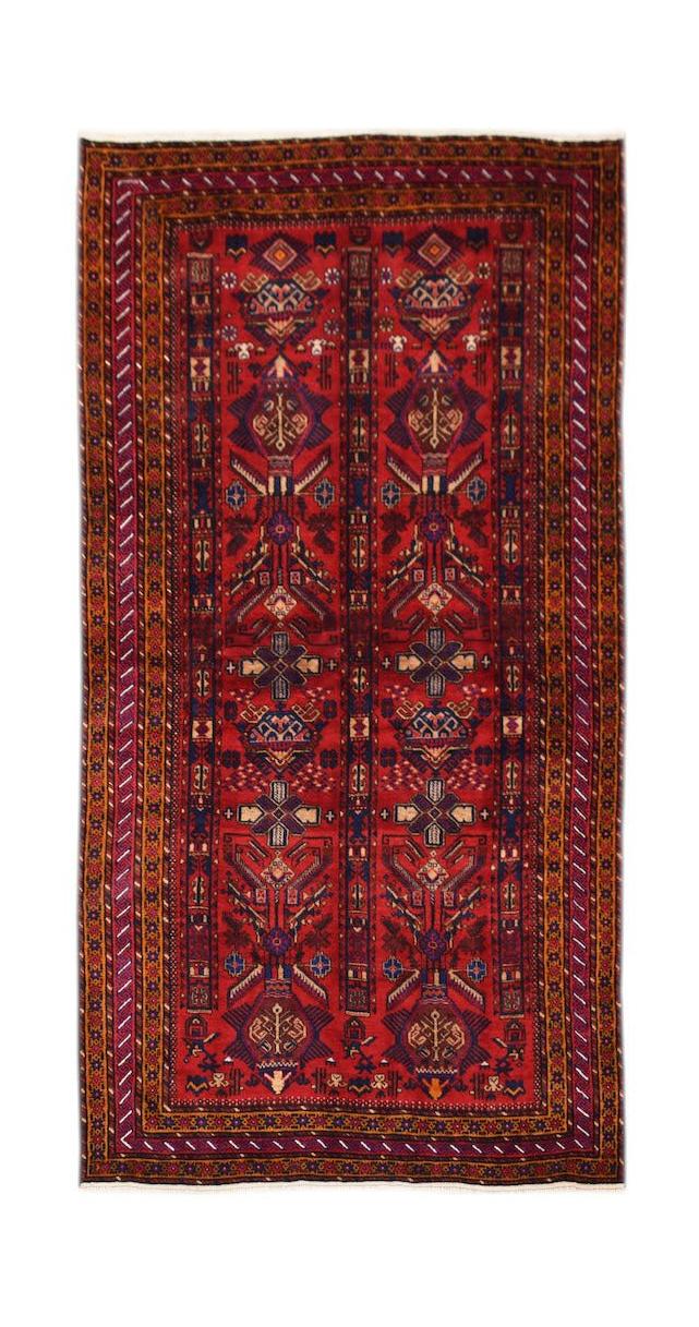 A vintage handmade Afghan Baluch rug featuring traditional geometric patterns in red and blue.