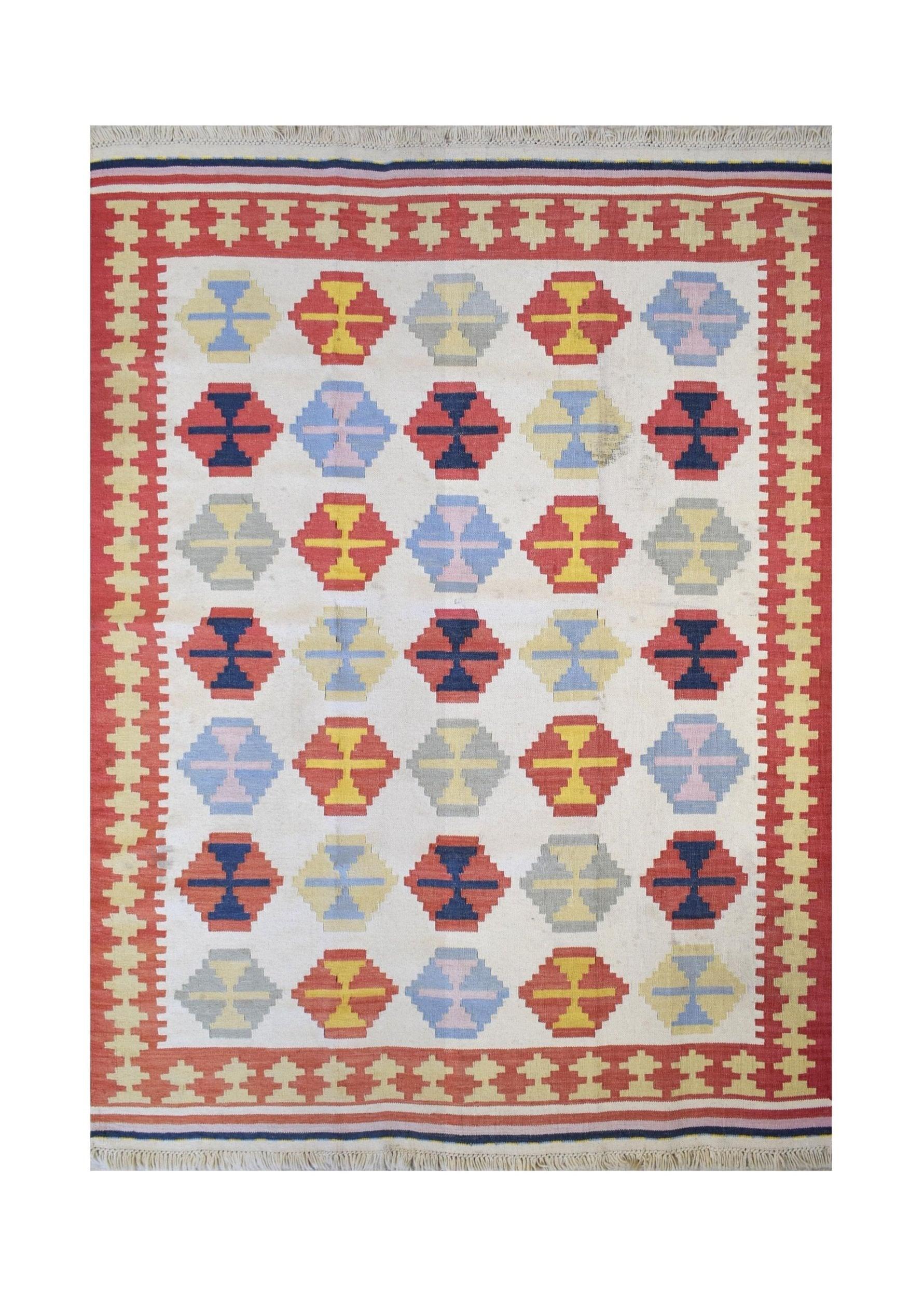 Handmade Turkish kilim rug featuring a repeating geometric pattern in red, blue, yellow, and grey.