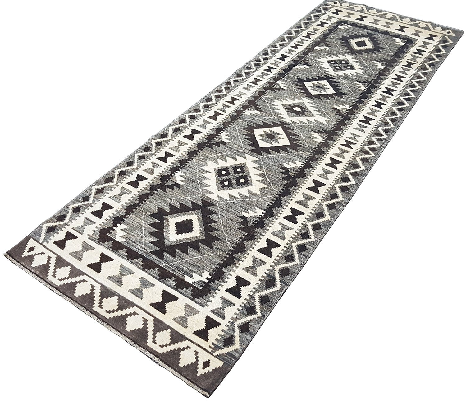 A handmade Afghan Chobi runner rug featuring a geometric pattern in shades of grey and cream.
