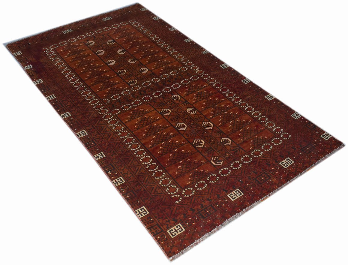A vintage handwoven Afghan Turkmen rug featuring a deep red field with geometric patterns.