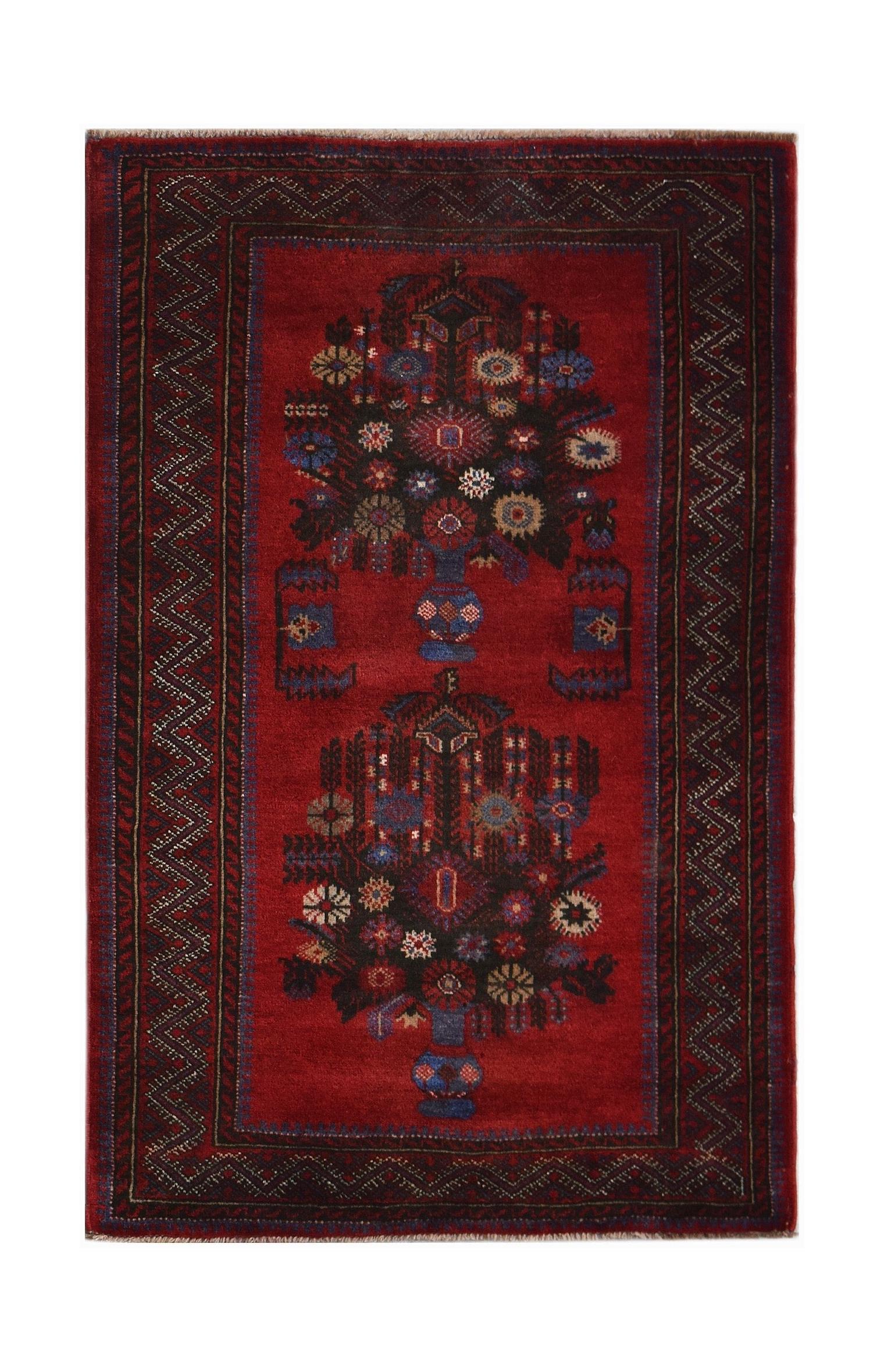 A vintage Afghan Baluch rug featuring two floral vase motifs on a deep red field.