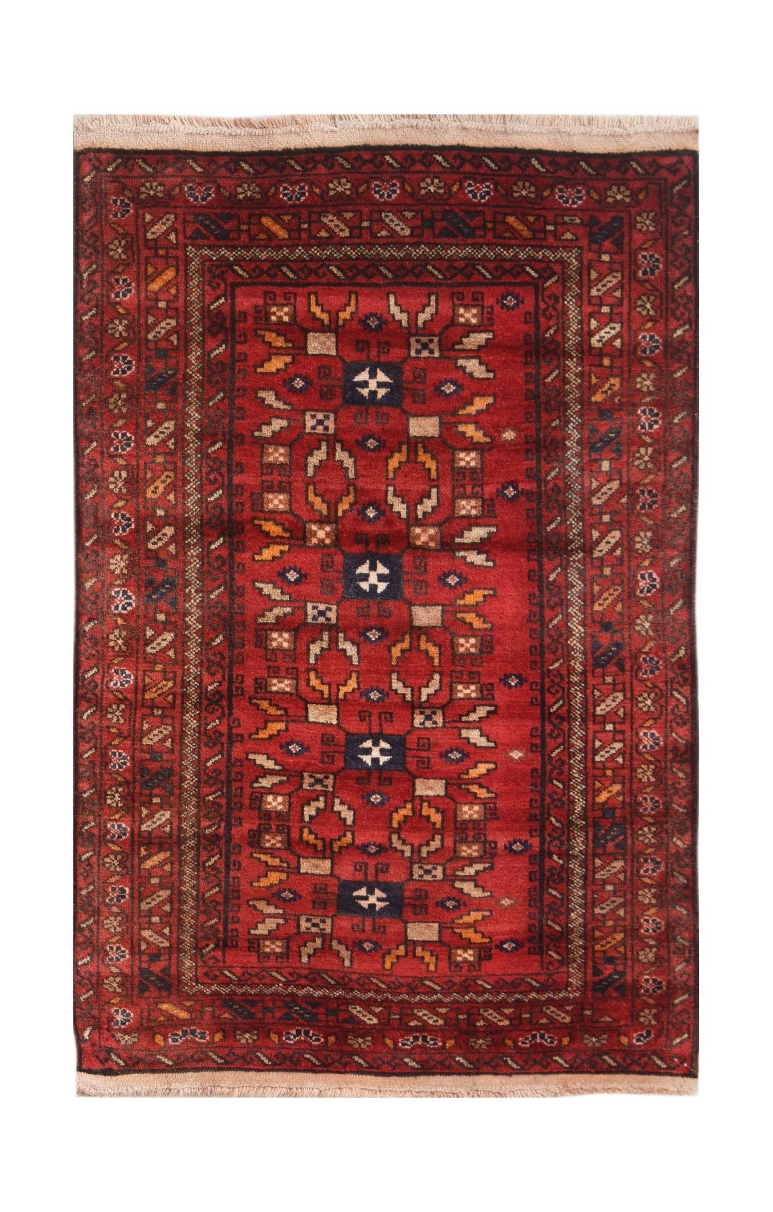 A vintage handwoven Afghan Baluch rug featuring geometric tribal patterns in shades of red.