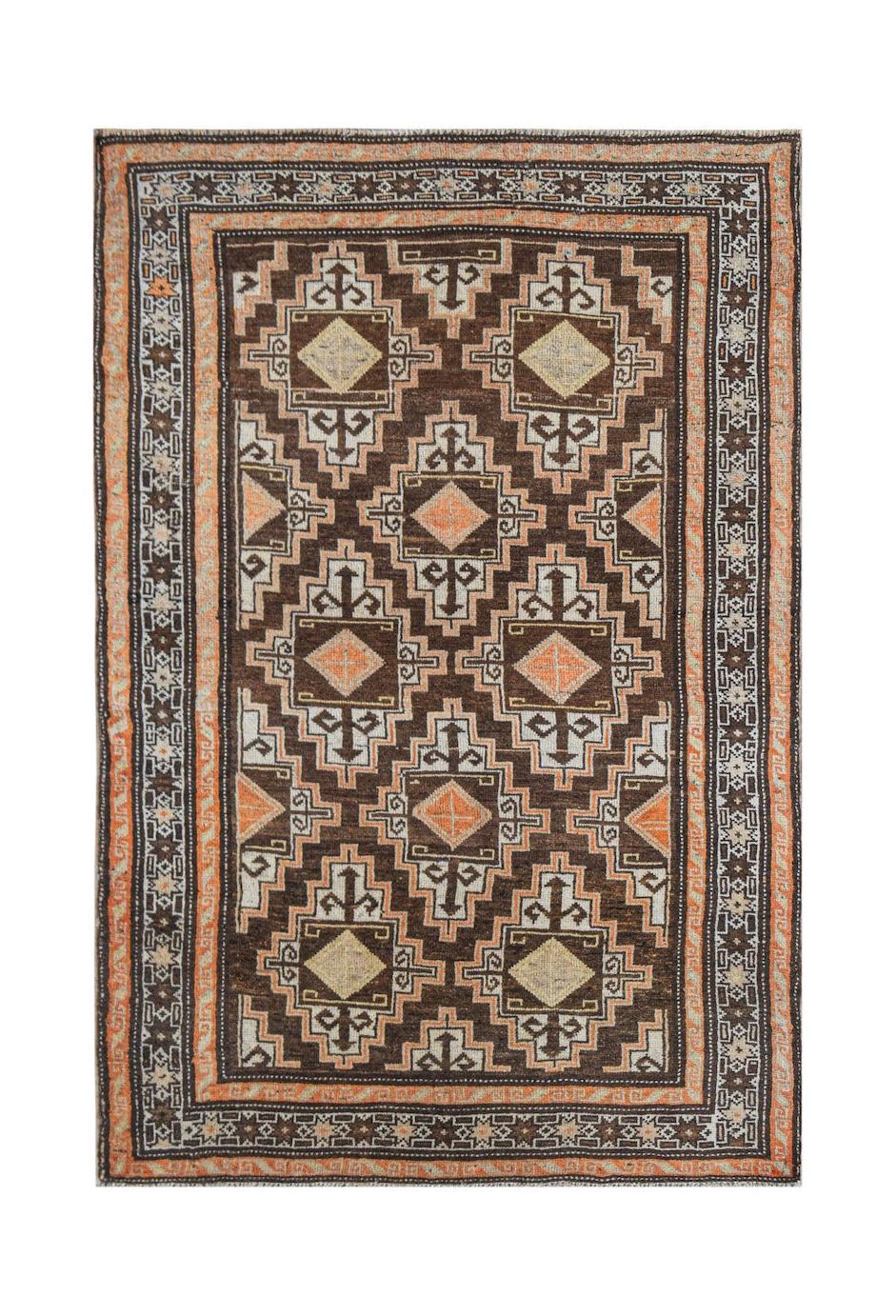 A vintage handwoven Afghan Baluch rug featuring a geometric diamond pattern in brown and orange.