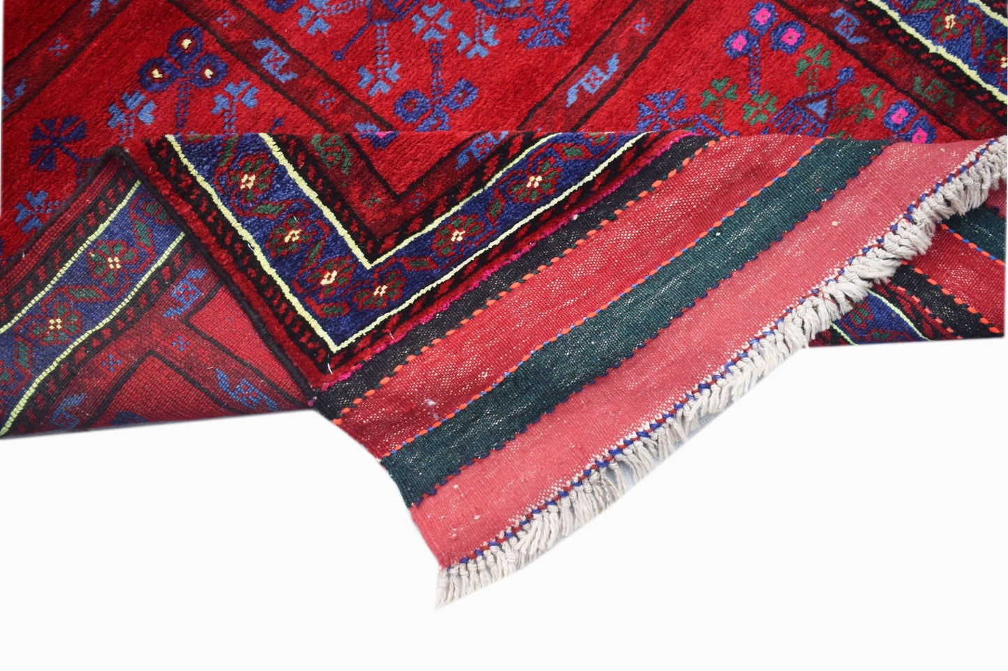 A handwoven vintage Afghan Baluch rug featuring a red field with blue floral patterns and fringe.