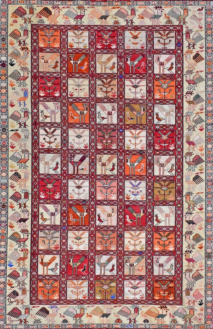 A vintage Afghan Sumak kilim featuring a grid of geometric bird motifs in vibrant wool and silk.