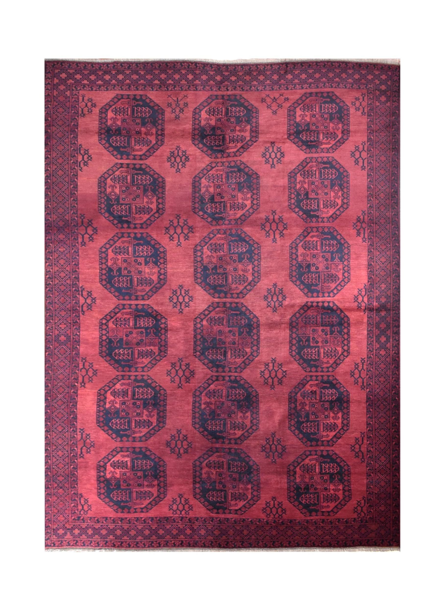 A vintage handmade Afghan Turkmen rug featuring repeating dark octagonal motifs on a red field.