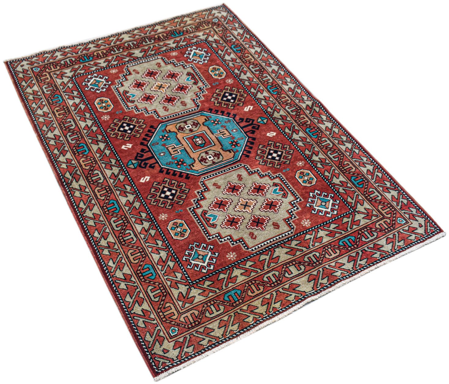 A handwoven vintage Caucasian rug featuring geometric patterns in red, blue, and beige tones.