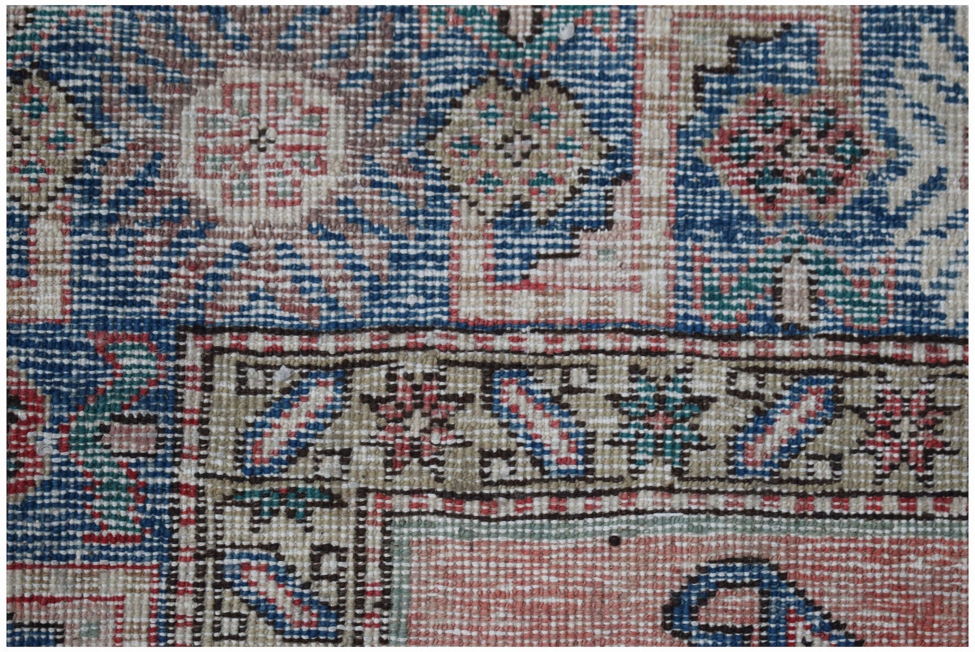 A vintage handmade Caucasian wool rug featuring a traditional geometric pattern in vibrant colors.