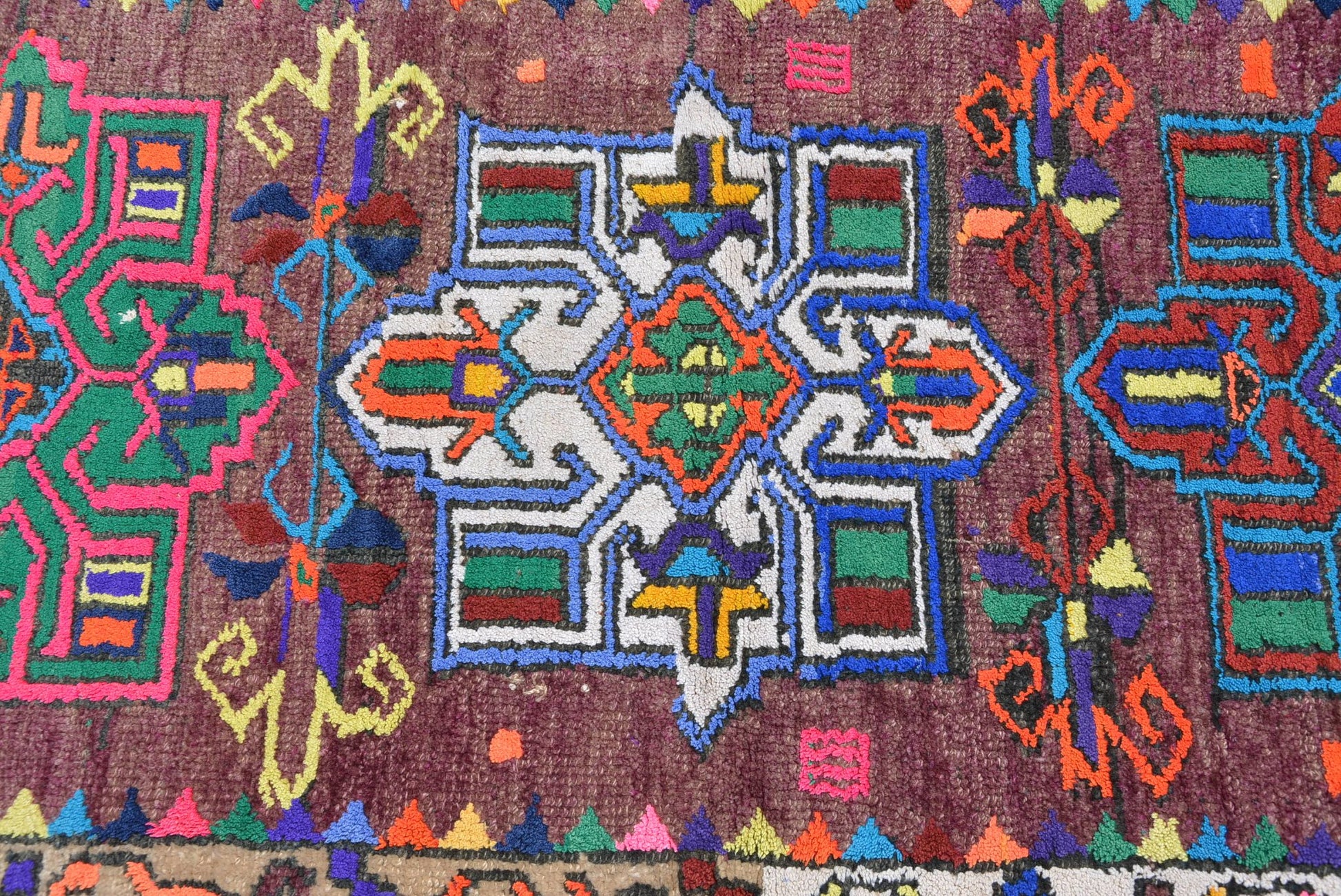 A vintage Kurdish Herki runner featuring a geometric tribal pattern in vibrant neon colors.