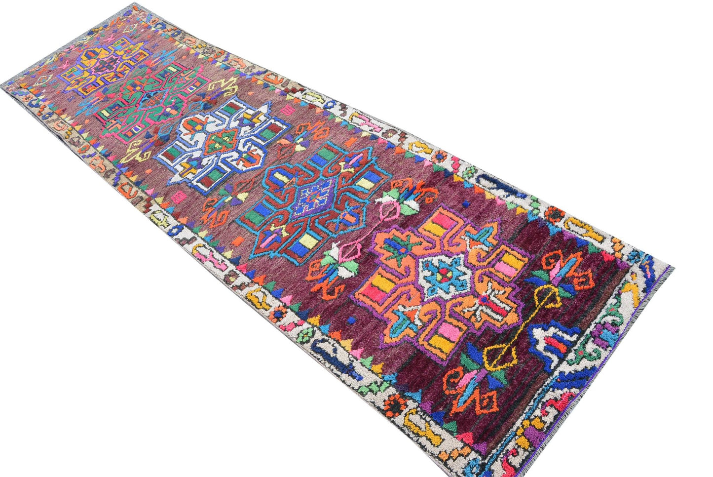 Vintage Kurdish Herki runner with tribal motifs in vibrant colors.