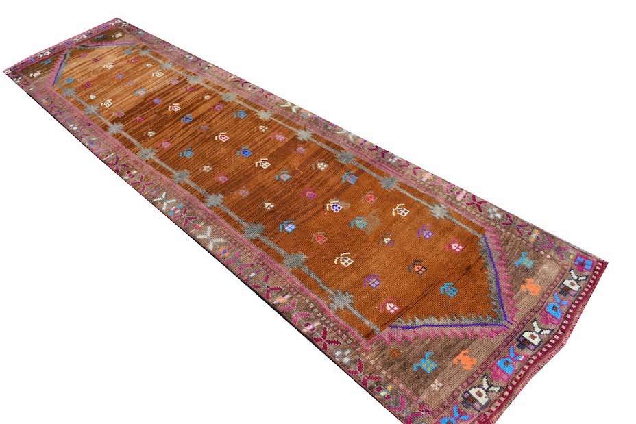 Vintage Kurdish Herki runner with tribal motifs in brown and colorful accents.