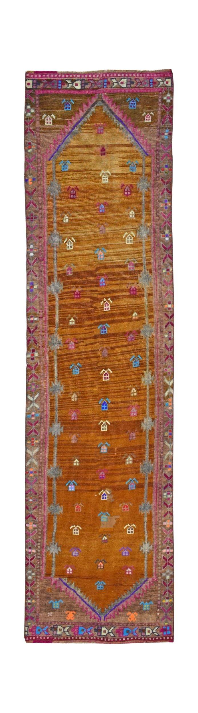 Vintage Kurdish Herki runner with tribal motifs and abrash color variation.