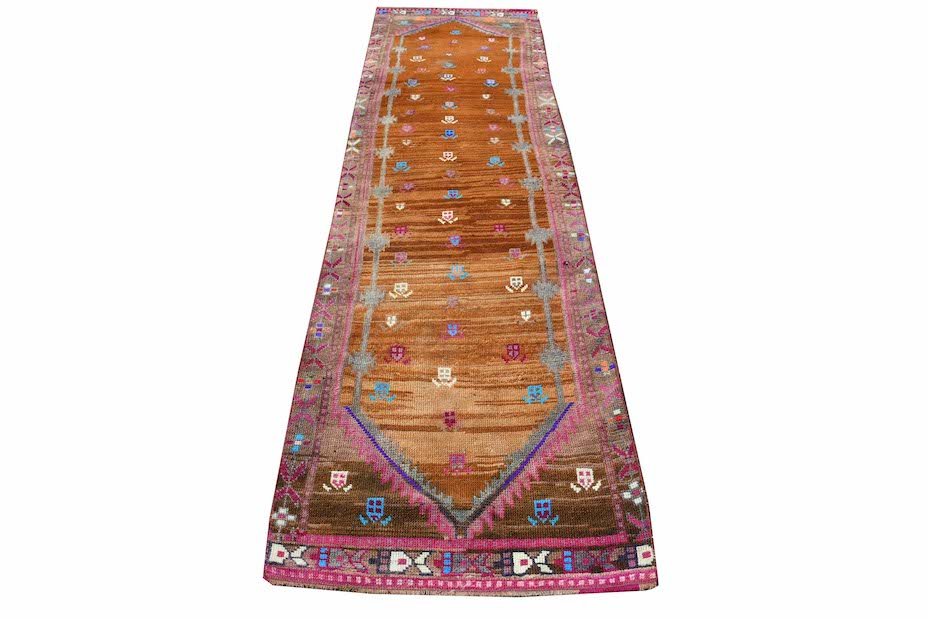 A vintage Kurdish Herki runner featuring tribal motifs in neon colors on an orange wool base.