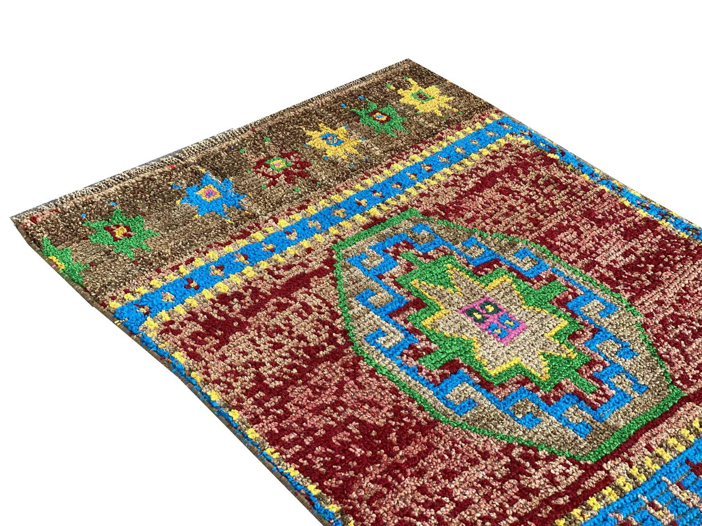A vintage Kurdish Herki runner featuring a geometric medallion in red, blue, green, and yellow.