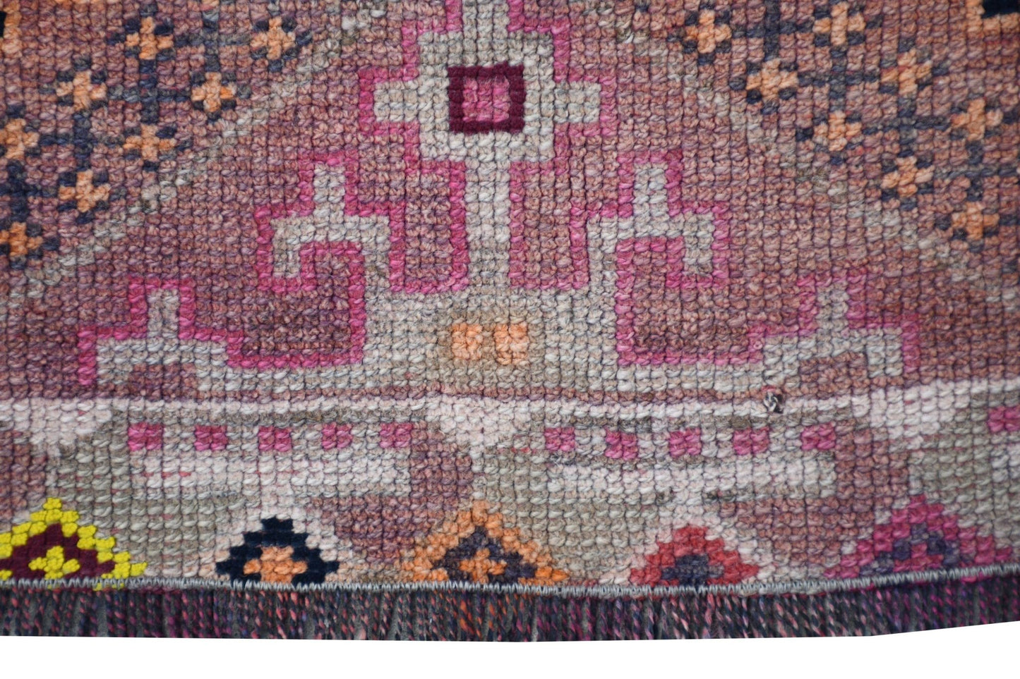 A vintage Kurdish Herki runner featuring tribal geometric motifs in wool and neon nylon accents.