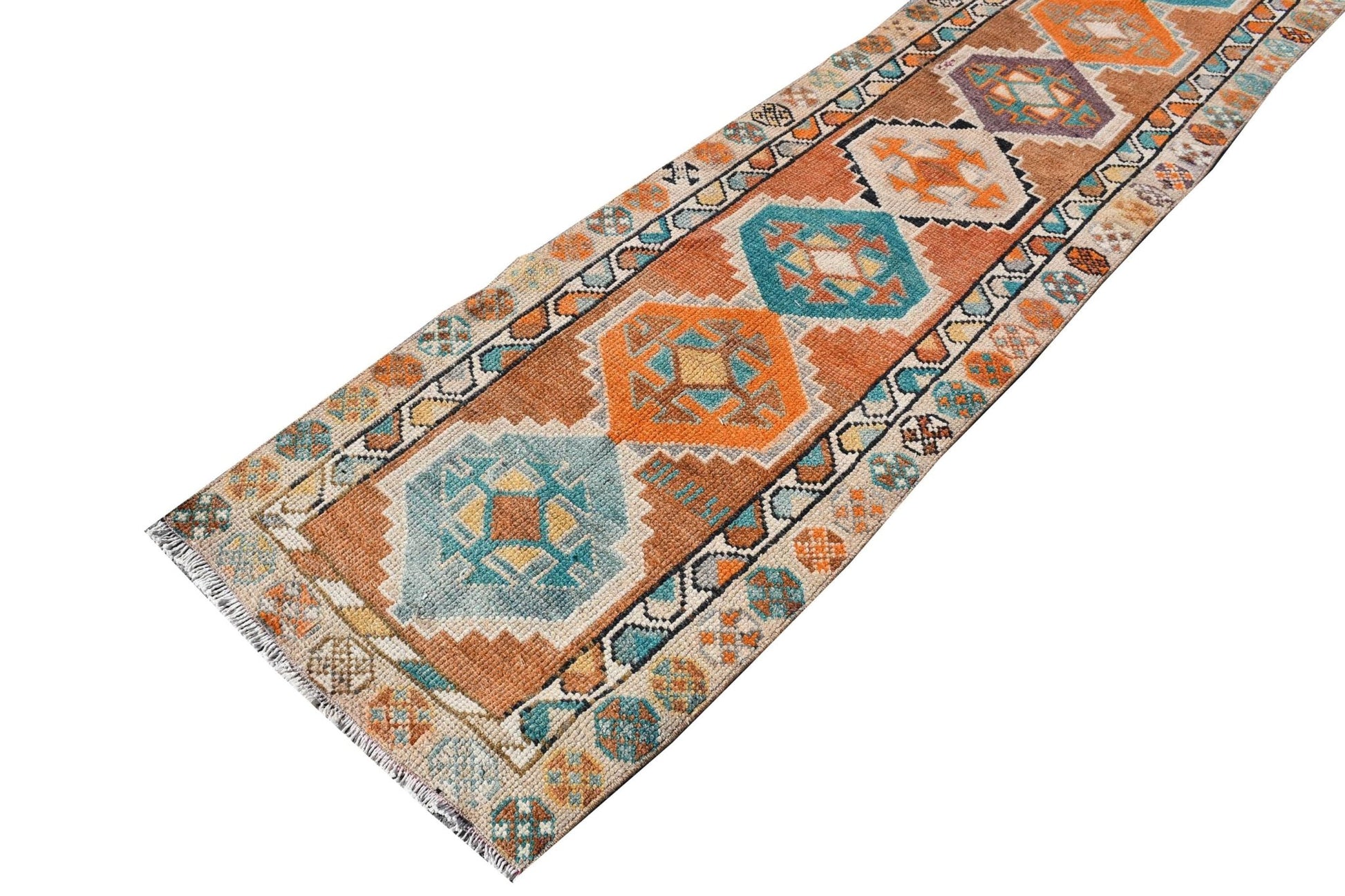 A vintage Kurdish Herki runner featuring geometric tribal motifs in vibrant orange and blue tones.