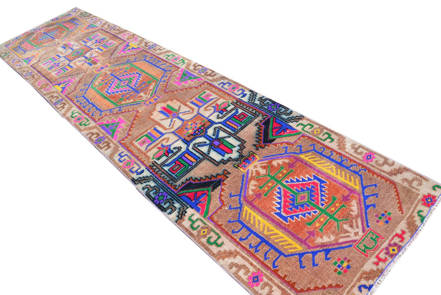 A vintage Kurdish Herki runner featuring vibrant tribal motifs on a brown wool base.