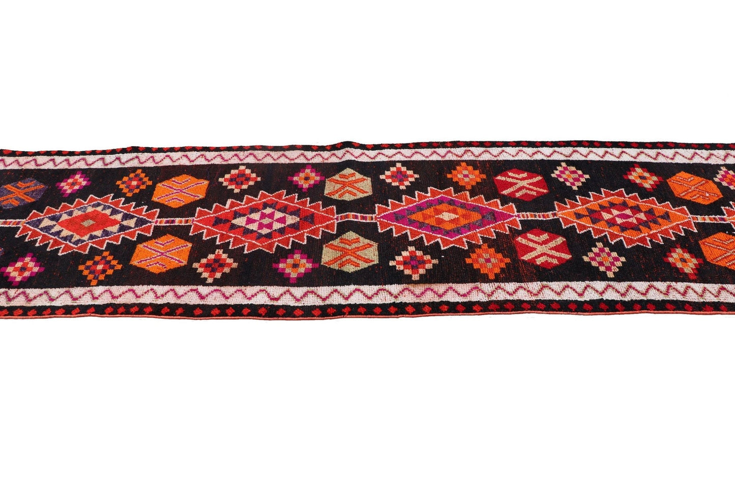 A vintage handmade Kurdish Herki runner featuring tribal geometric motifs in vibrant colors.