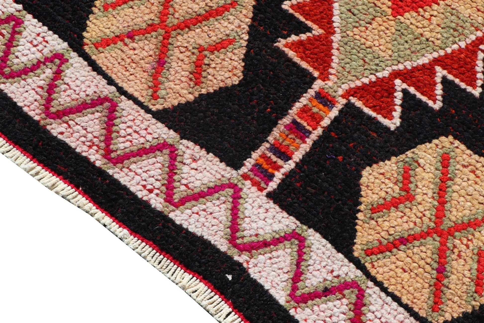 A vintage Kurdish Herki runner featuring tribal motifs in vibrant neon colors on a black background.
