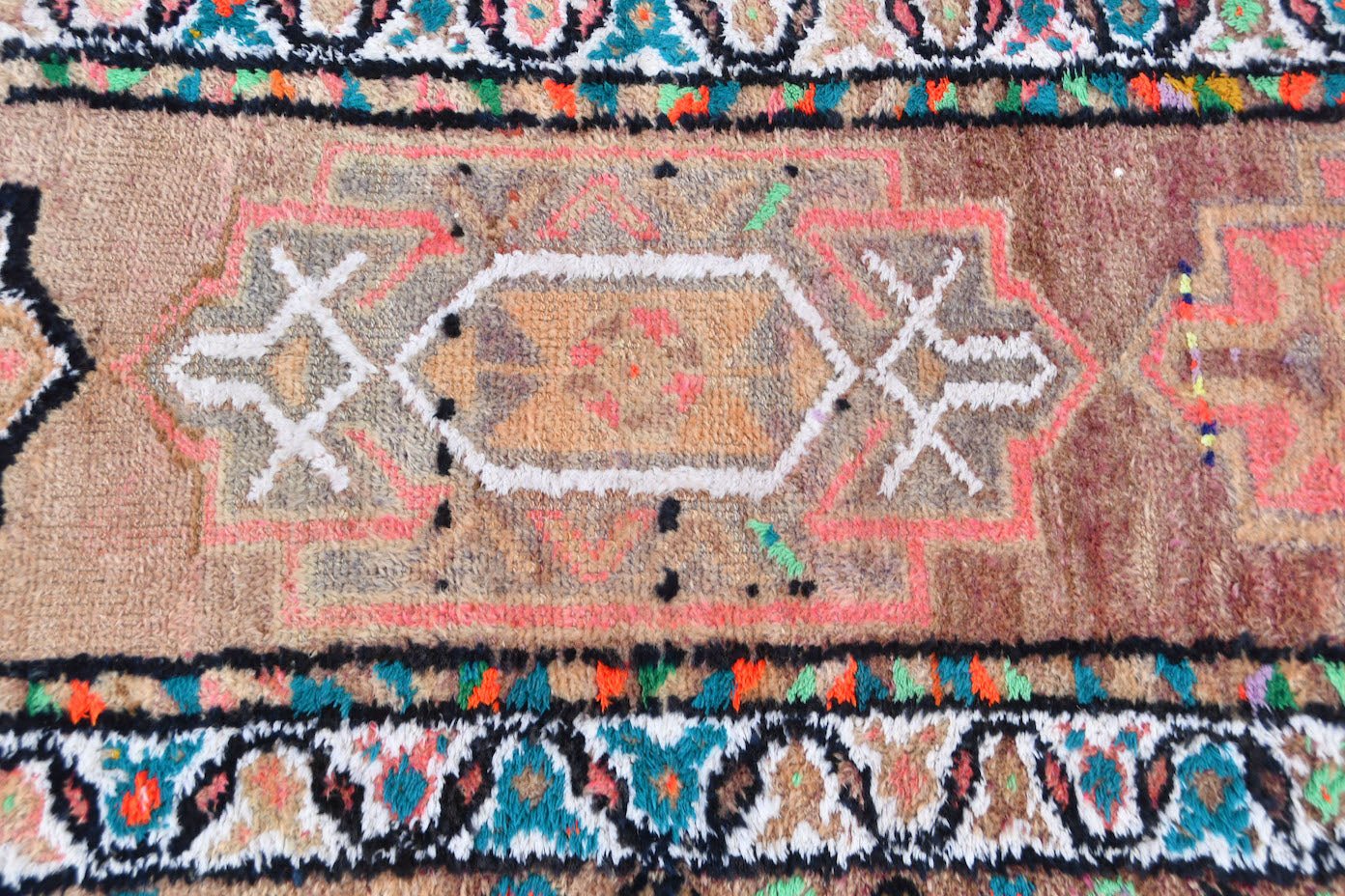 A vintage Kurdish Herki runner featuring tribal geometric motifs in wool and neon nylon.