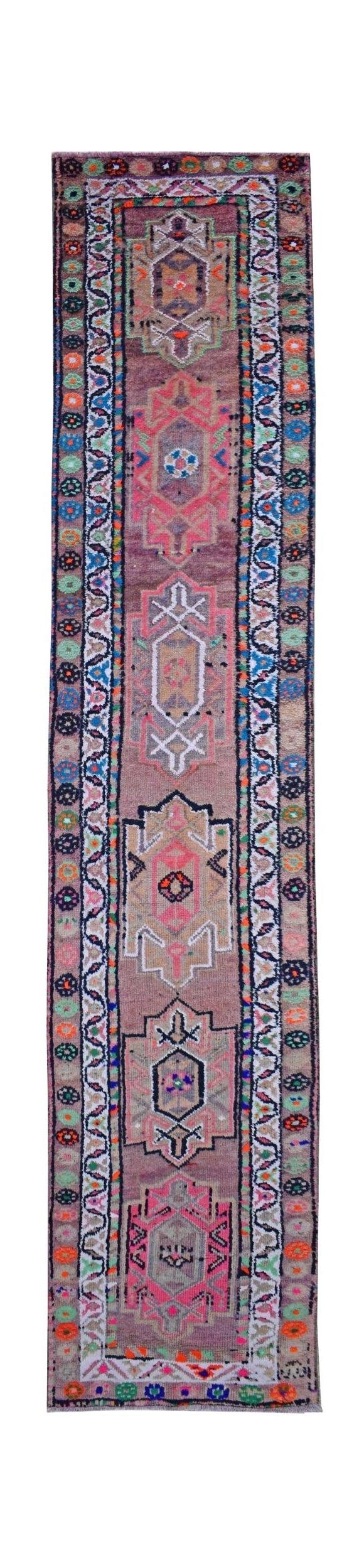 A vintage Kurdish Herki runner featuring tribal geometric motifs in vibrant neon colors.