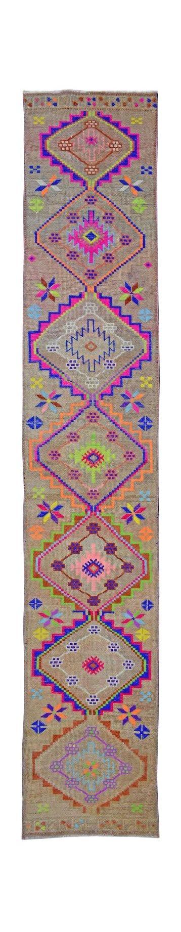 A vintage Kurdish Herki runner featuring tribal diamond motifs in vibrant neon colors.