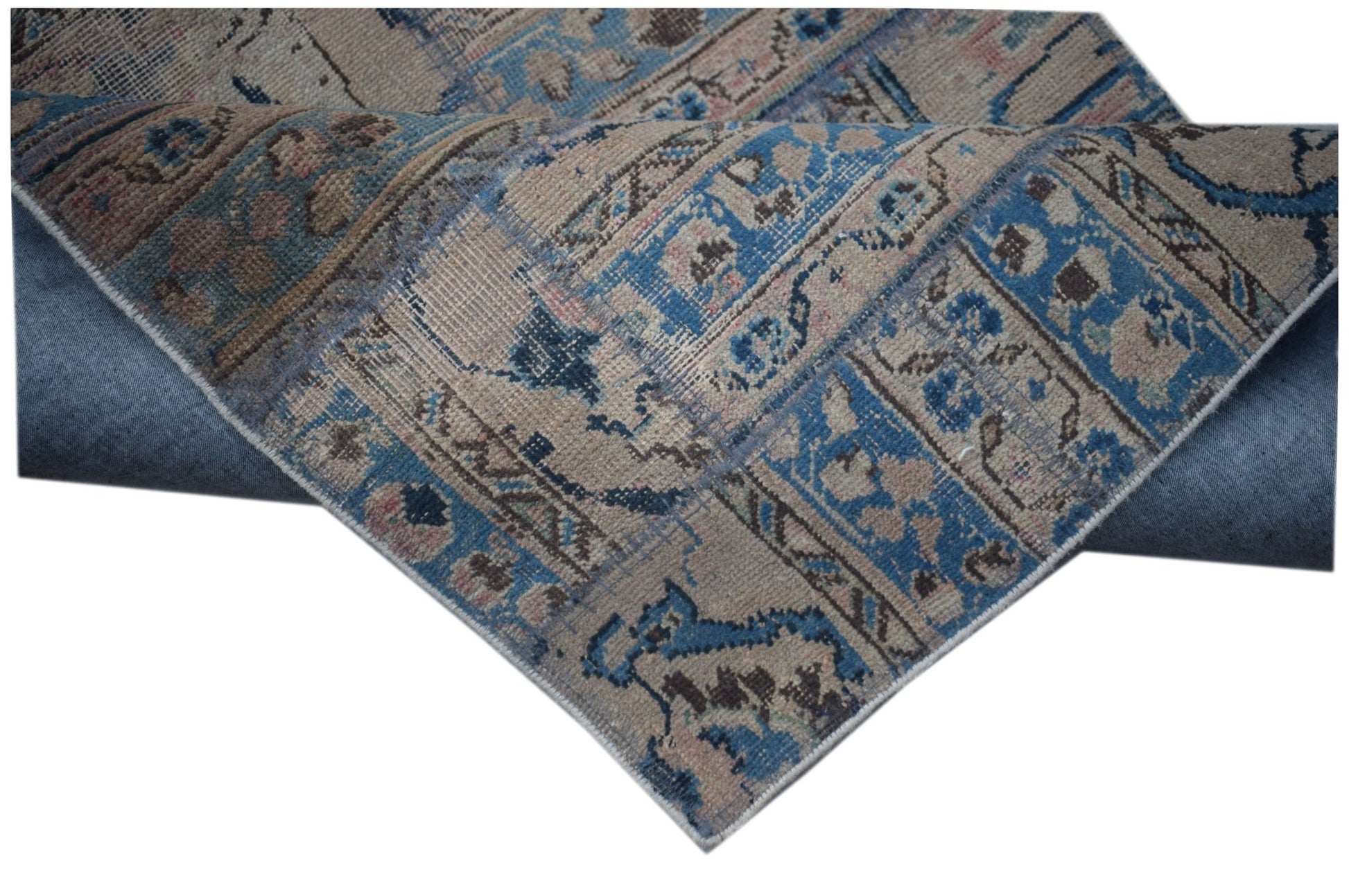 A vintage patchwork runner featuring a distressed blue and beige wool pattern.