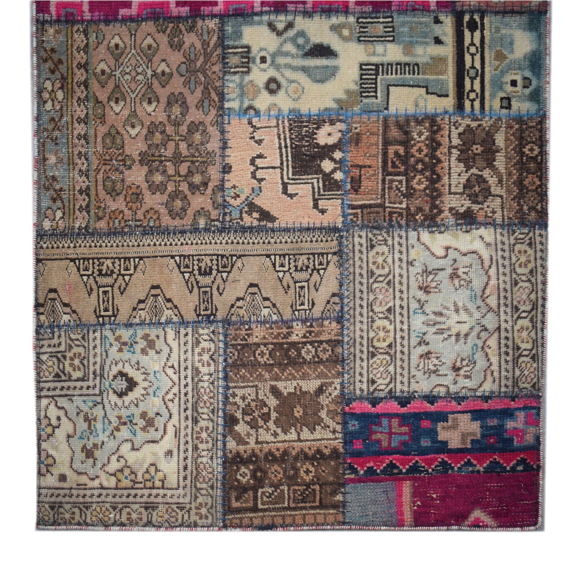 A handmade vintage patchwork runner featuring a variety of wool rug fragments in earthy tones.