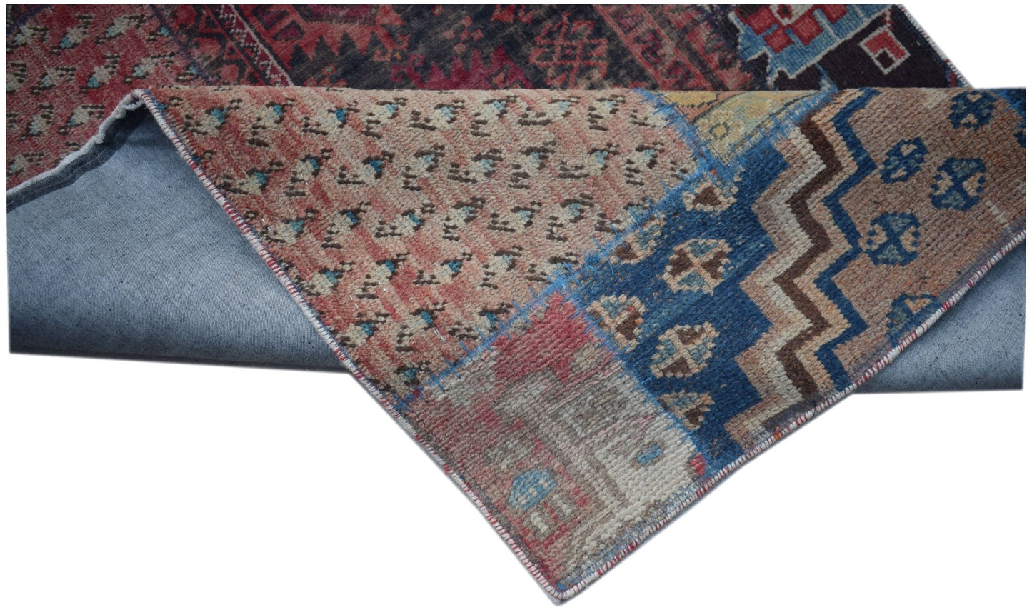 A vintage patchwork runner featuring a mix of colorful wool patterns on a cotton foundation.