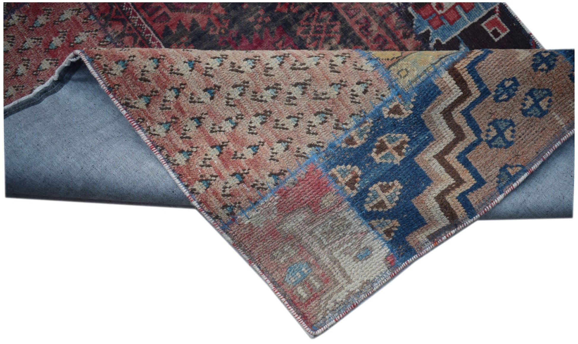 A vintage patchwork runner featuring a mix of colorful wool patterns on a cotton foundation.