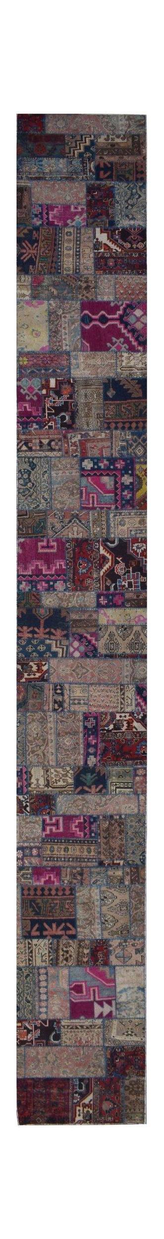 A long, handmade vintage patchwork runner rug featuring a colorful mix of wool textile patterns.