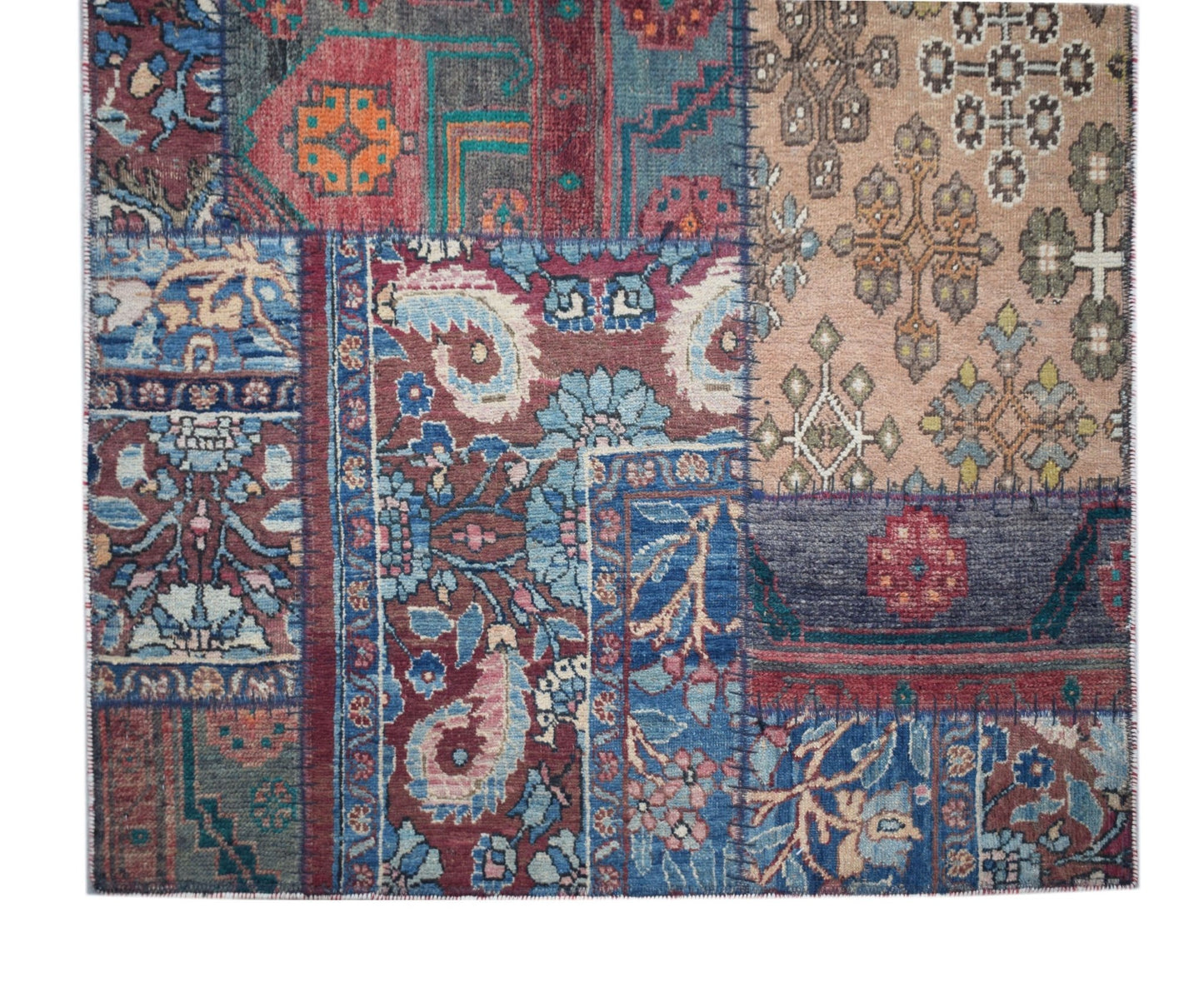 A handmade vintage patchwork runner featuring a variety of colorful, intricate wool patterns.